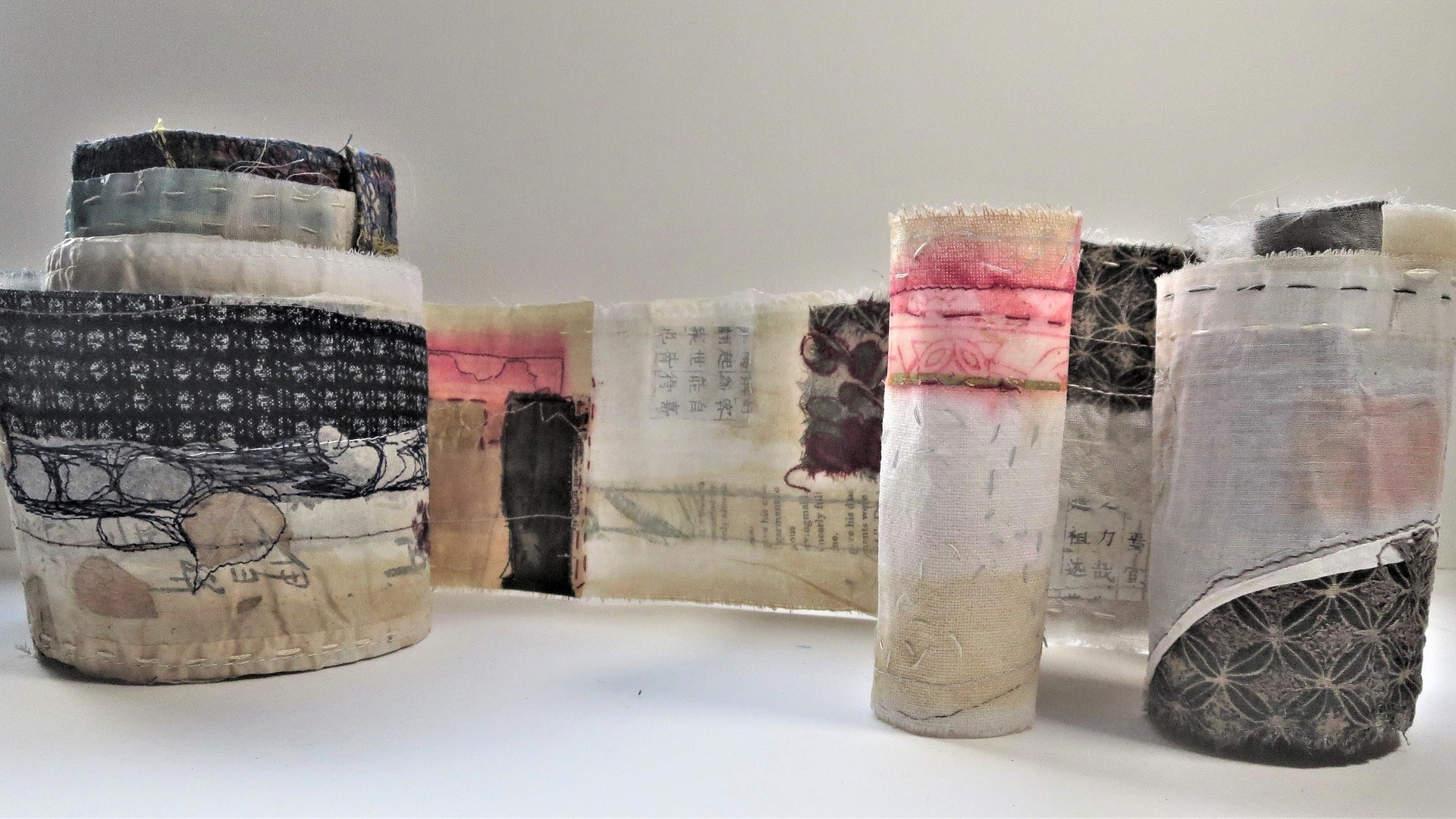 textile art piece in a scroll with collage and marks