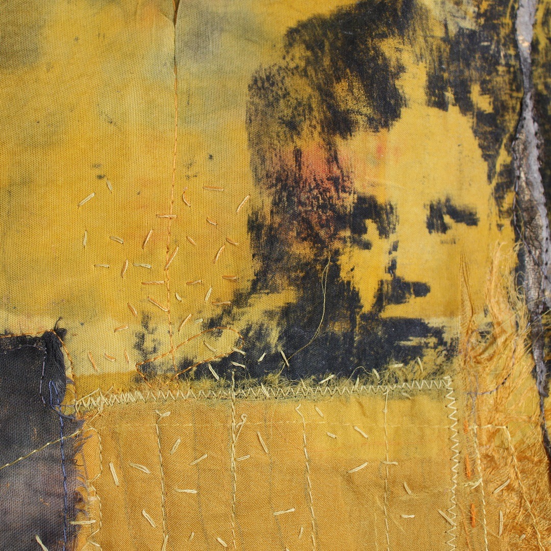 Textile Art piece with childs face and embroidery