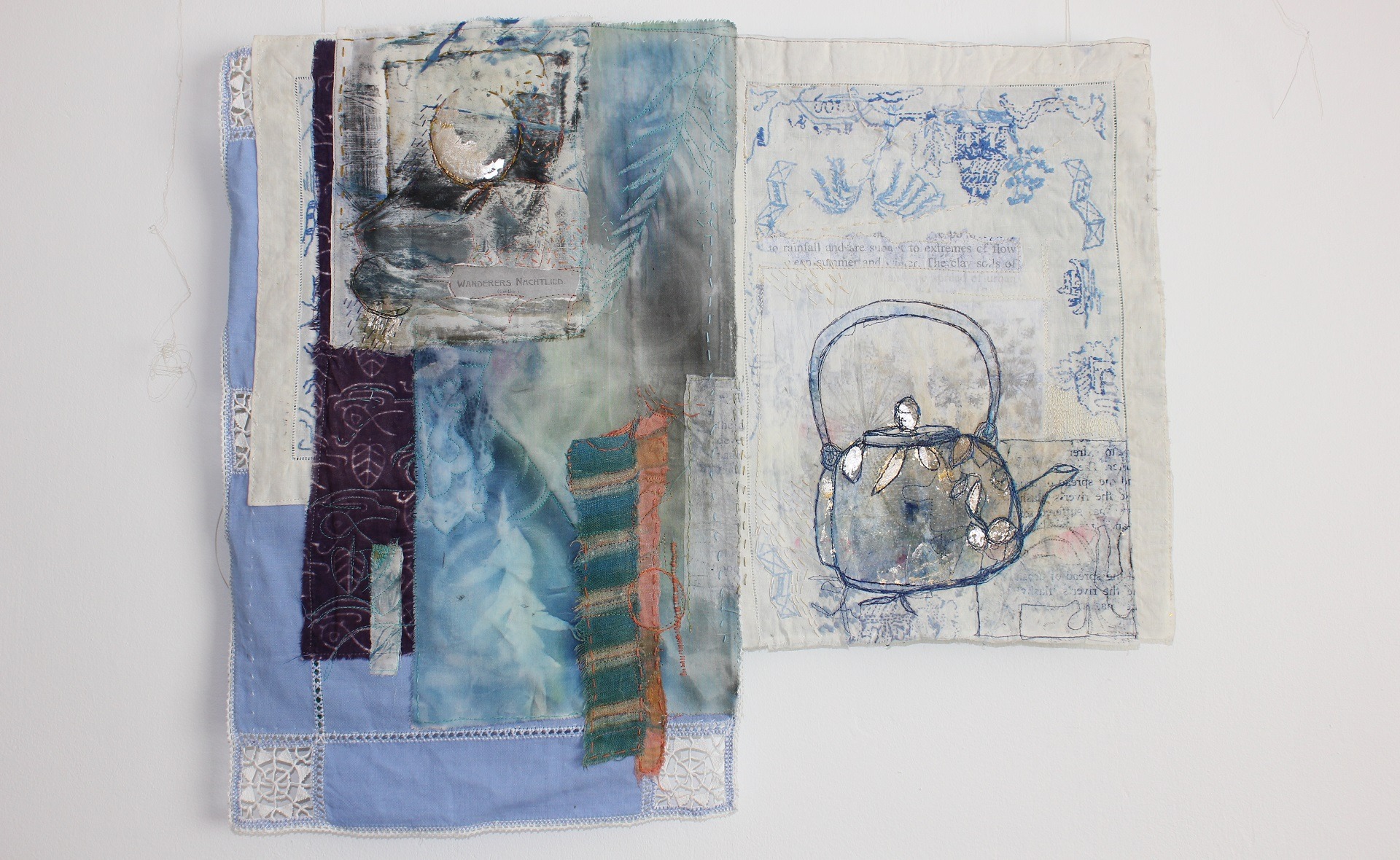 Collage textile art piece with an embroidered kettle