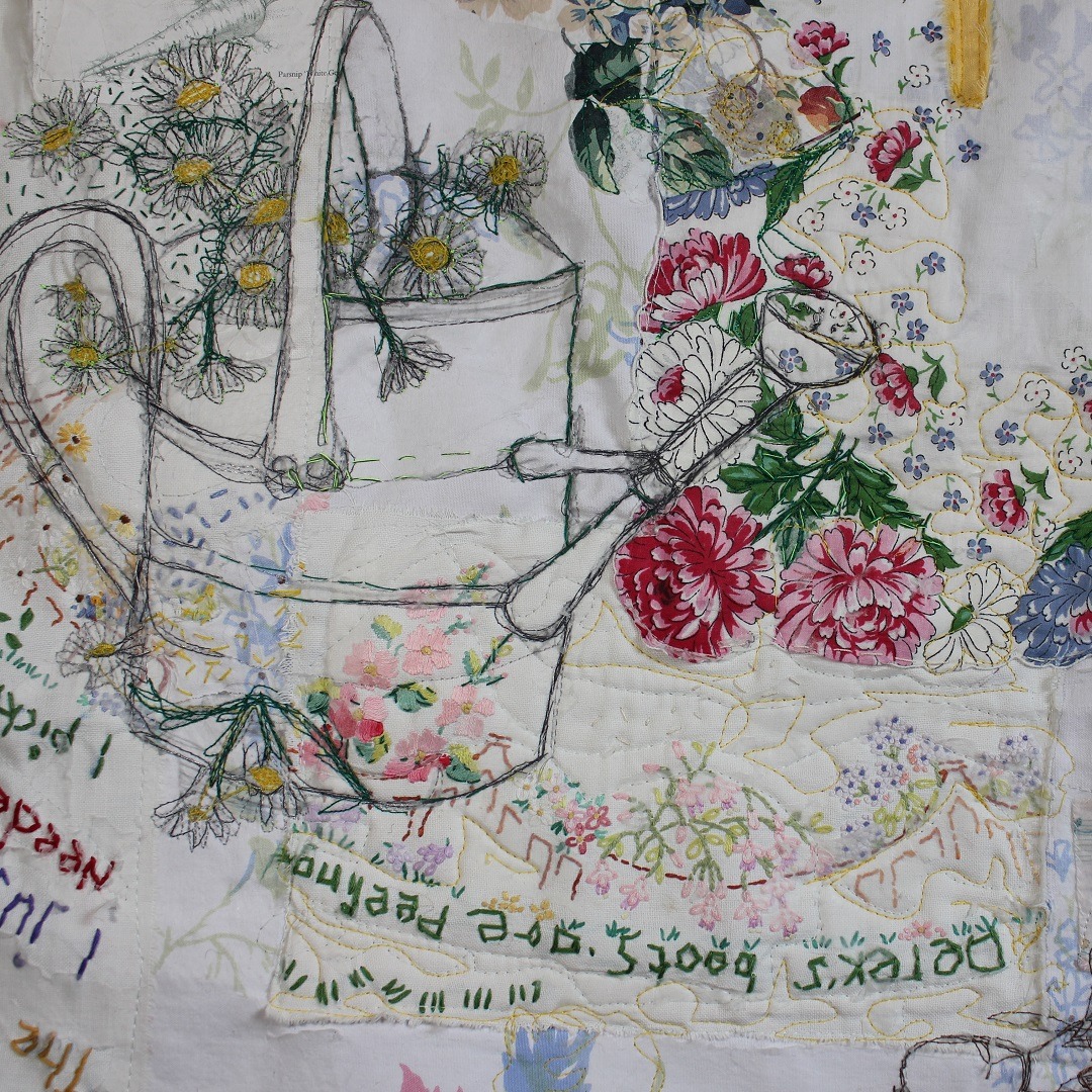 Close up of a textile art of embroidered flowers, text and a watering can