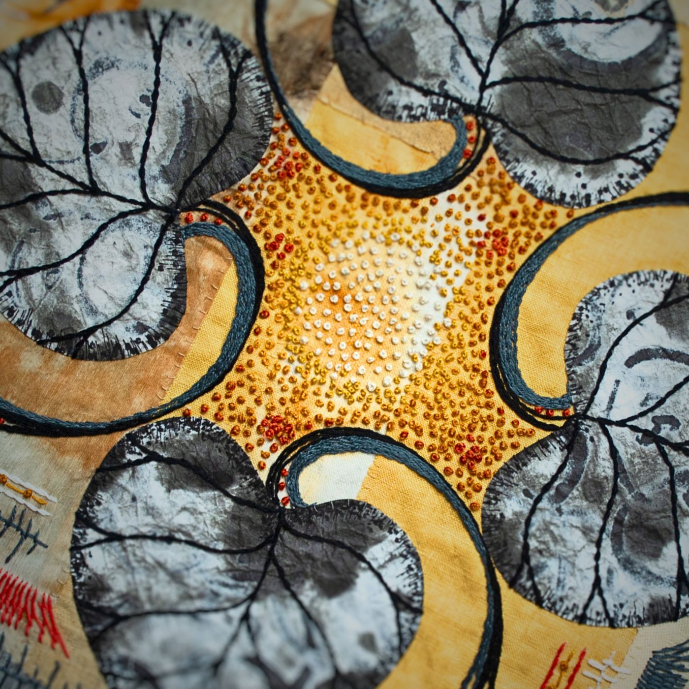 Intricate stitched floral design with textured leaves