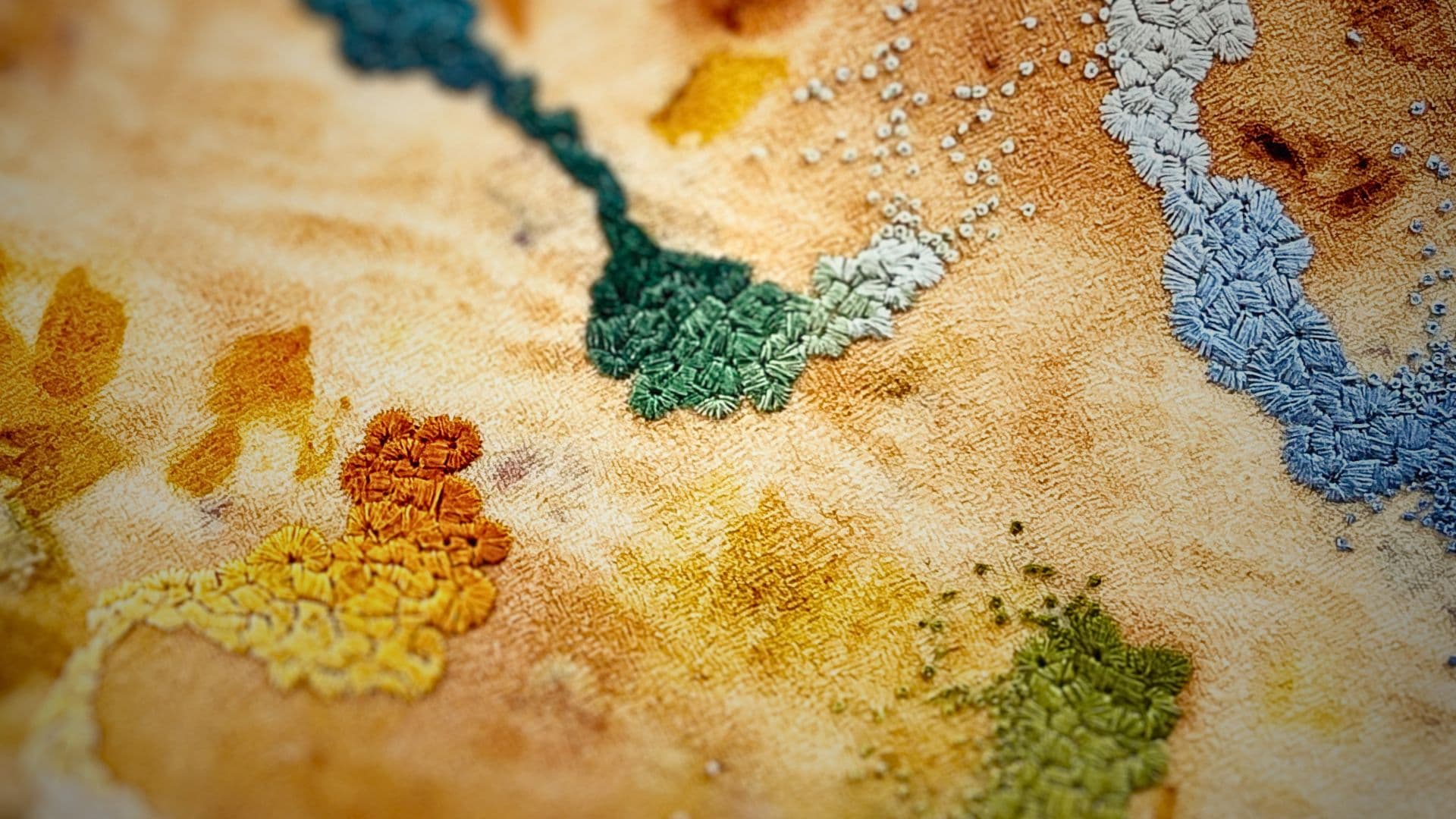 A close up of a fabric with abstract colourful french knots