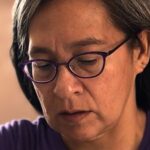 A close up image of textile artist Rosemary Meza-DesPlas working in her studio.