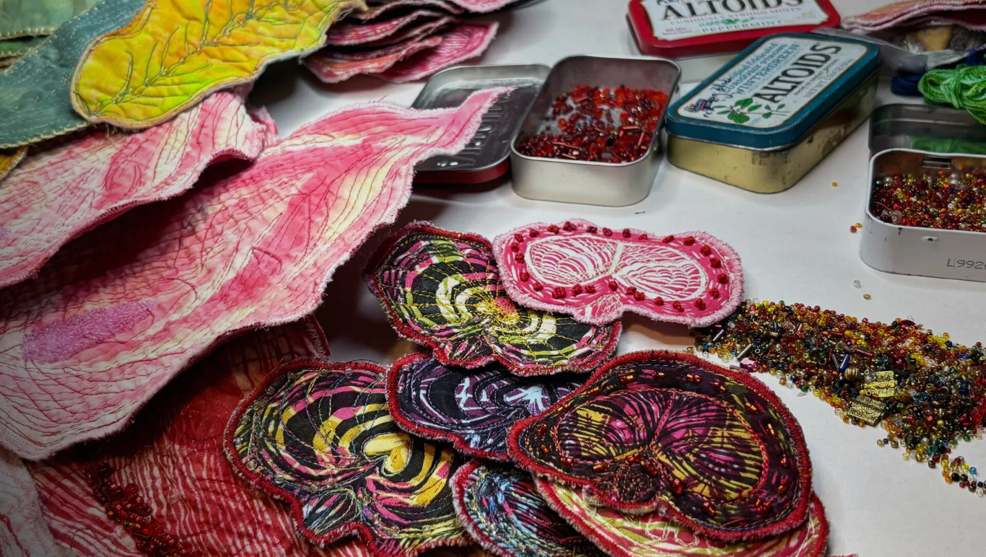 Lauren Austin, sections for a new piece All Within Me, 2024. 305cm x 142cm (120" x 56"). Appliqué, screen printing, hand dyeing, press printing, woodcut, linoleum block printing, machine quilt drawing, machine quilting, beading, embroidery. Cotton, felted wool, beads.